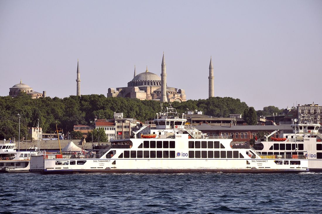 A ferry crossing the Bosphorus with the historic Istanbul skyline behind